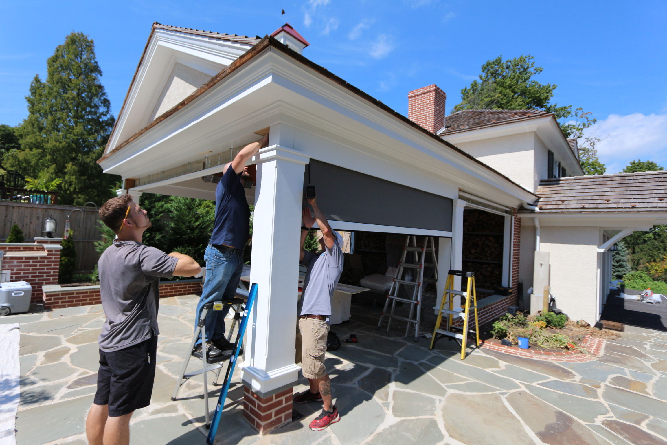 Ambiance Design installers and men from Domers Construction installing Rainier outdoor shades