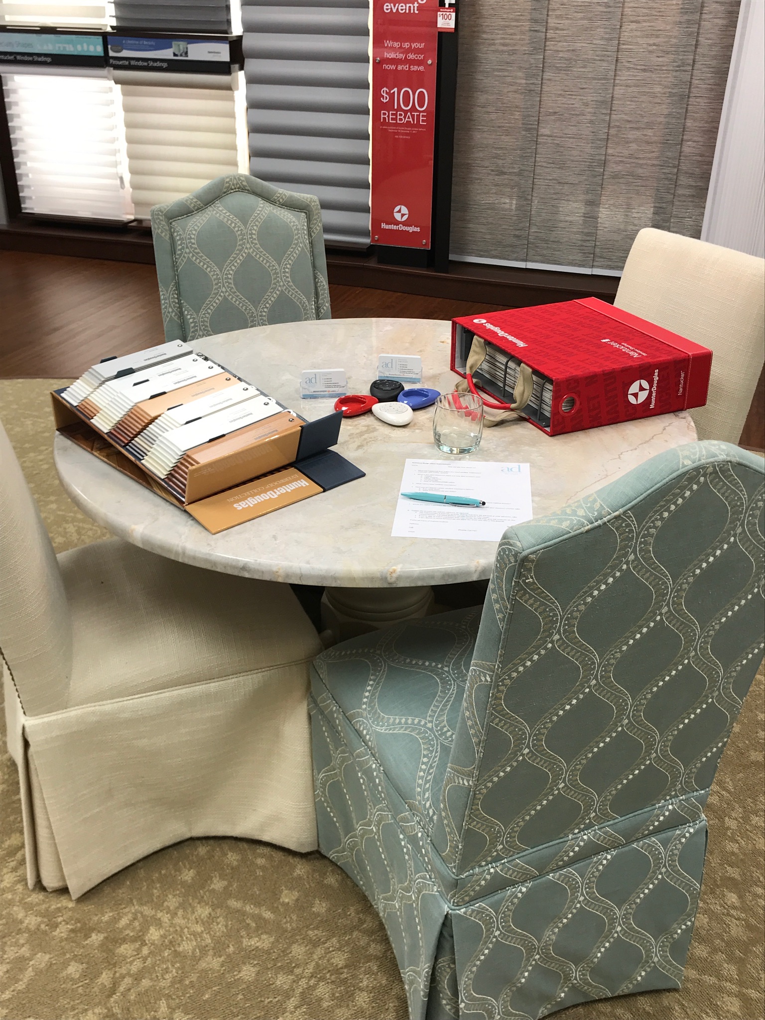 table set up for a showroom consultation with window treatment product books