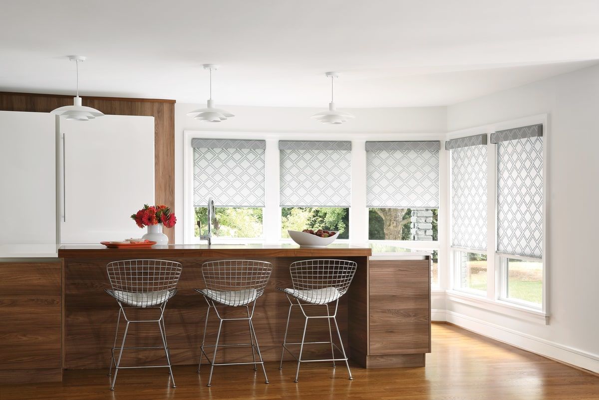 Hardwood floor kitchen with geometric patterned Designer Roller Shades