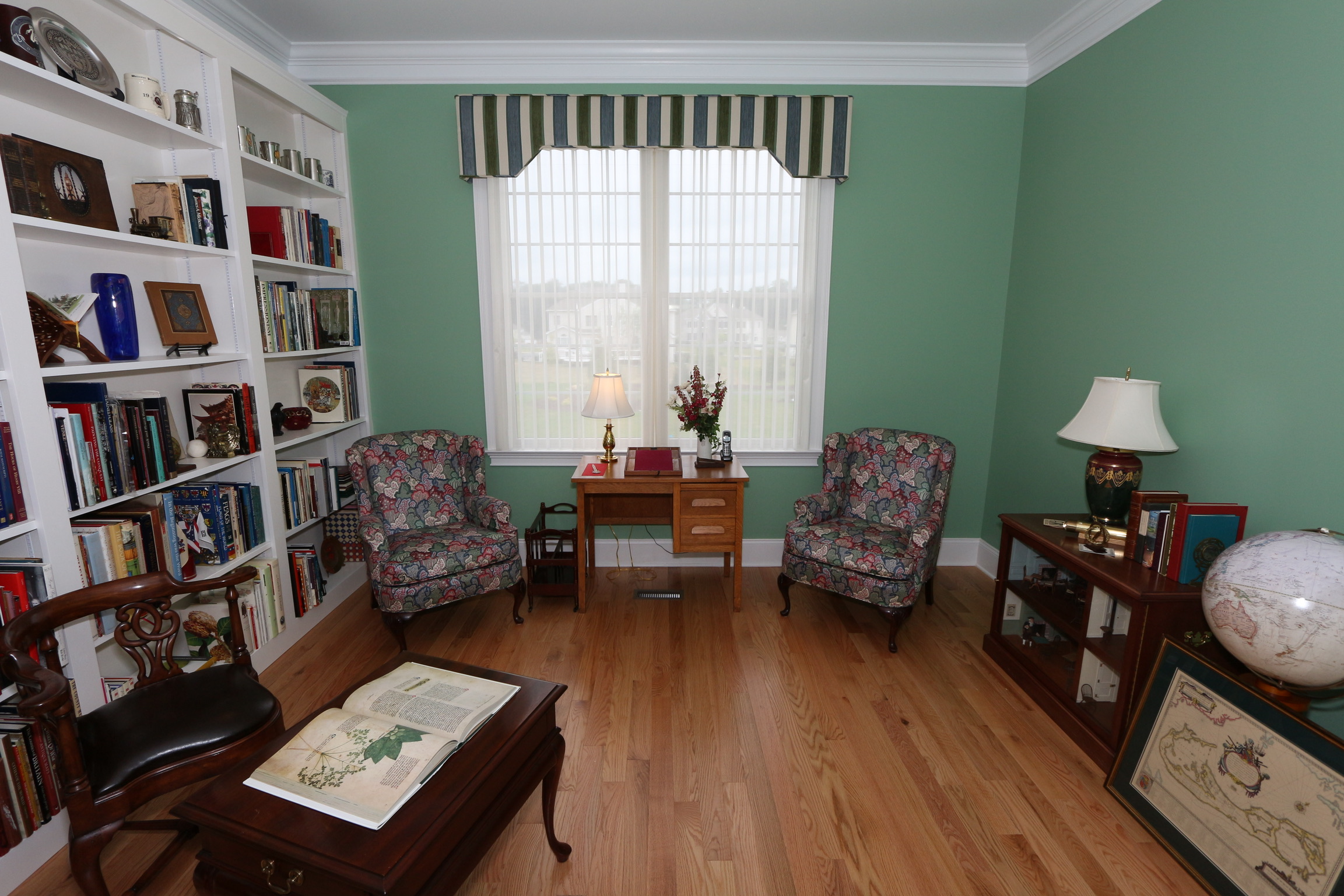 Office Lounge of mixed patterns: green striped cornice and "splotched" chairs