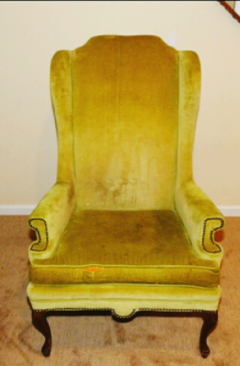 ripped, stained, and outdated gold wingback chair in need of upholstery services